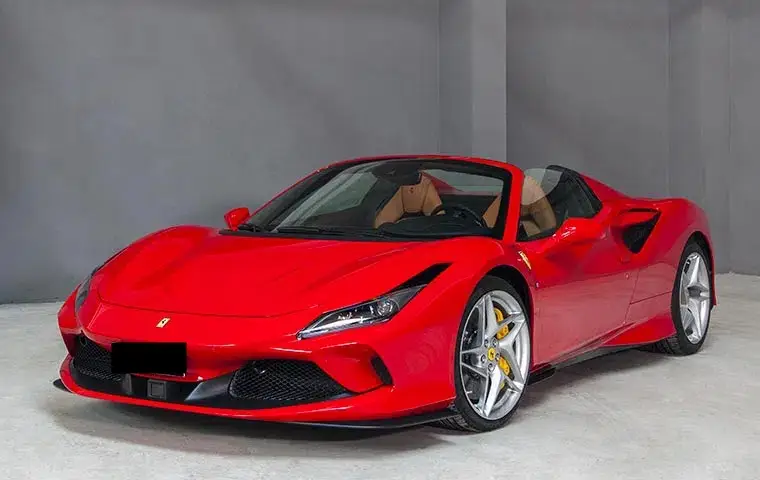 Ferrari F8 Tributo Spider Red 2023, front view — Barcelona Luxury Car Rental, Barcelona. The Ferrari F8 Tributo Spider in red pairs a twin-turbocharged V8 producing 720 hp with a…