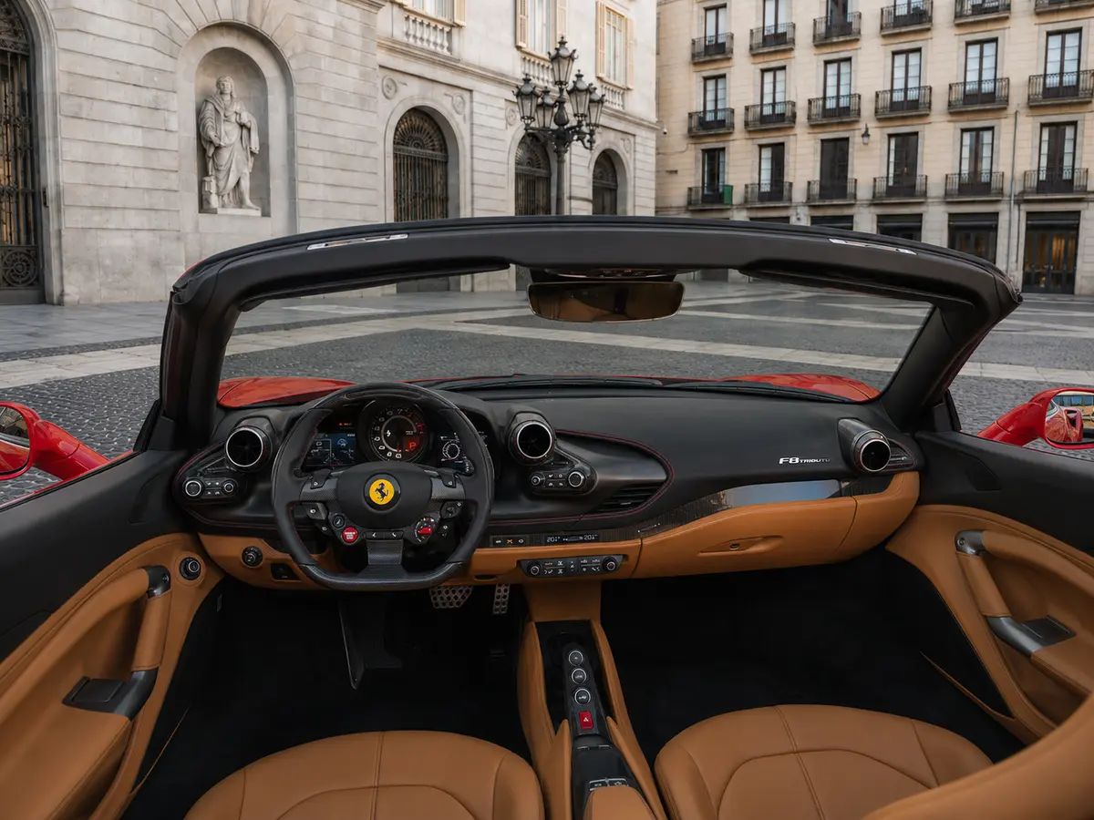Ferrari F8 Tributo Spider Red 2023, interior — Barcelona Luxury Car Rental, Barcelona. The Ferrari F8 Tributo Spider in red pairs a twin-turbocharged V8 producing 720 hp with a…