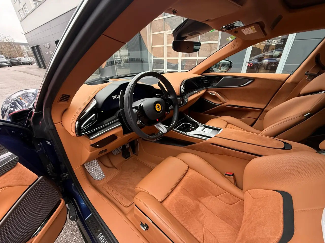 Ferrari Purosangue 2024, rear view — Barcelona Luxury Car Rental, Barcelona. The Ferrari Purosangue occupies a category of its own within the marque's line-up: five…