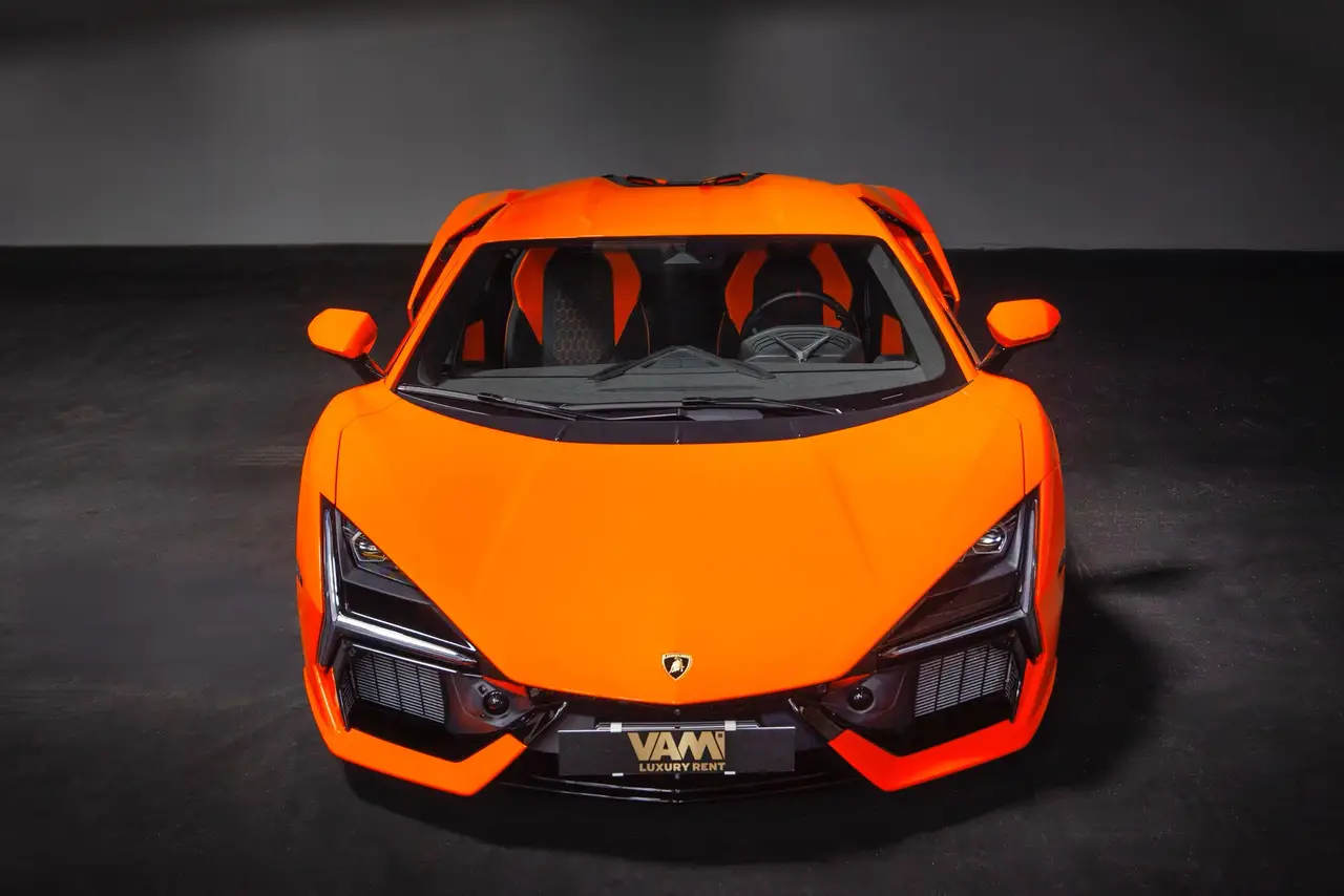 Lamborghini Revuelto 2026, rear view — Barcelona Luxury Car Rental, Barcelona. The Lamborghini Revuelto is the marque's current flagship, pairing a naturally aspirated…