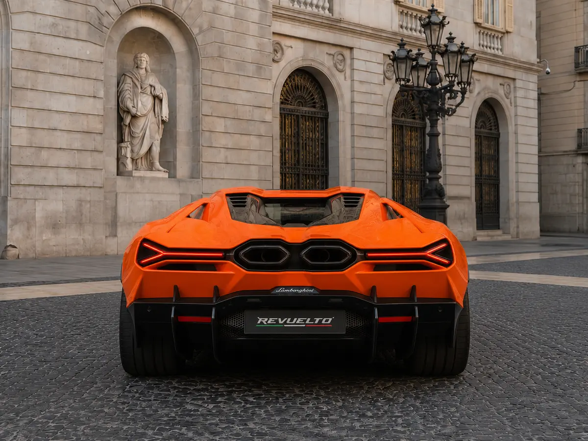 Lamborghini Revuelto 2026, rear view — Barcelona Luxury Car Rental, Barcelona. The Lamborghini Revuelto is the marque's current flagship, pairing a naturally aspirated…