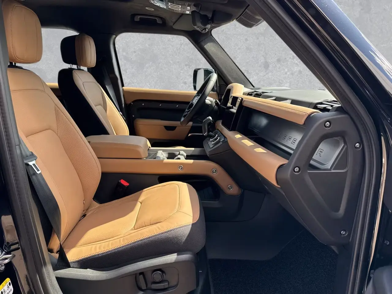 Land Rover Defender 2024, front view — Barcelona Luxury Car Rental, Barcelona. The 2024 Land Rover Defender in this fleet carries 400 hp and seats seven, which puts it…