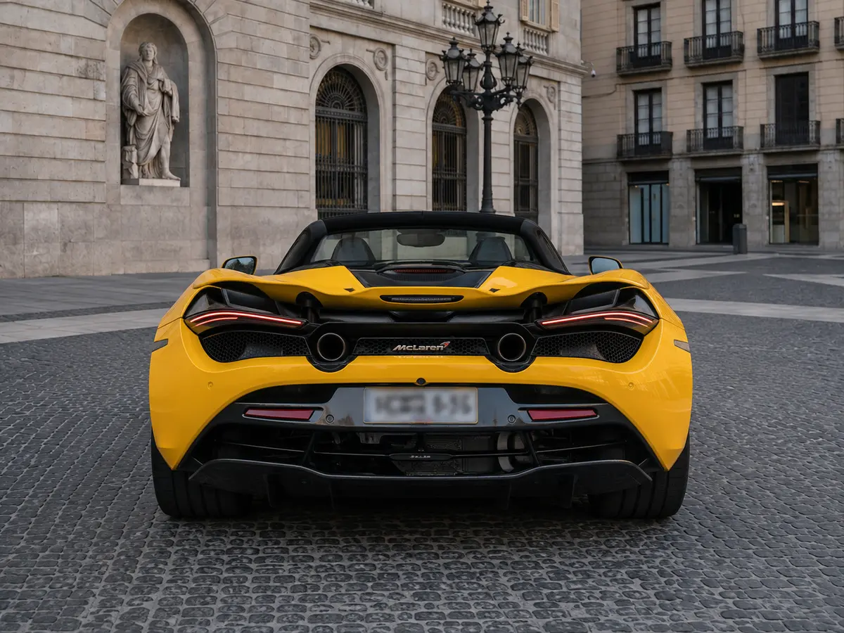 McLaren 720S Spider 2022, rear view — Barcelona Luxury Car Rental, Barcelona. The McLaren 720S Spider pairs a 720 hp twin-turbo V8 with a two-seat carbon cockpit built…